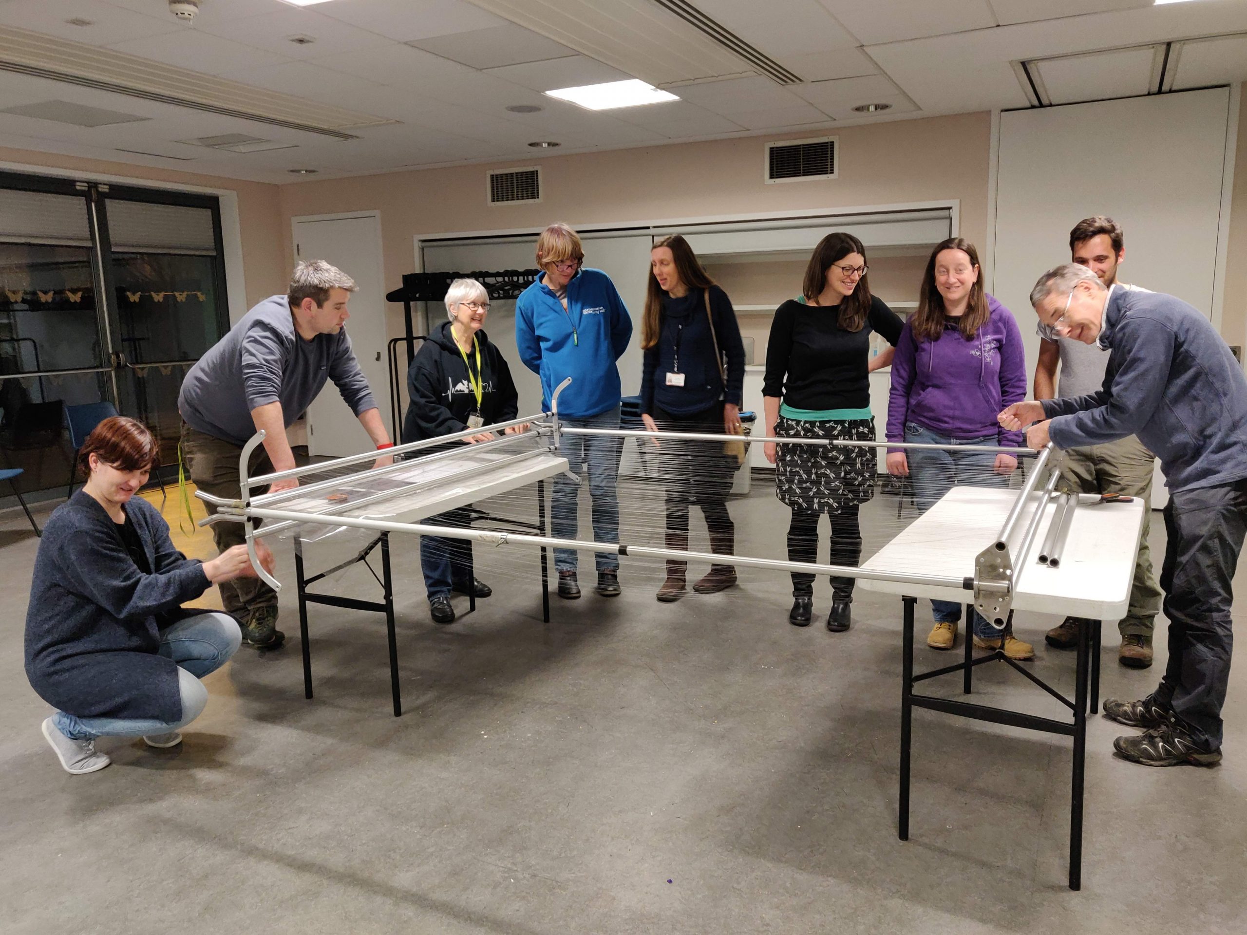 Group standing around harp trap